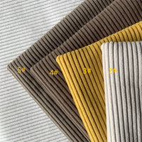 Four swatches of Longan Craft 4.5 Wale Polyester Corduroy Fabric are stacked diagonally in light gray, brown, mustard yellow, and beige. Each solid color upholstery fabric is labeled 5#, 4#, 3#, and 2# from left to right.