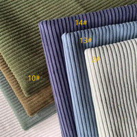 Stack of Longan Craft 4.5 Wale Polyester Corduroy Fabric by the yard in solid colors—green, brown, blue, and gray. Wide wale corduroy ideal for pants; some pieces labeled with yellow numbers: 10#, 14#, 13#, and 2#.