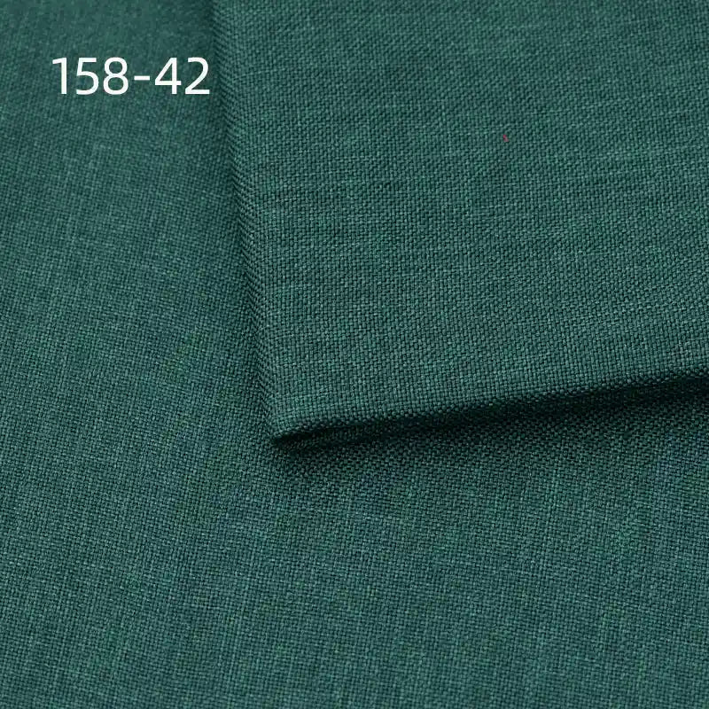 Longan Craft Faux Linen Upholstery Fabric in dark green polyester is shown with a folded corner revealing weave detail. The listing number 158-42 appears in white text at the upper left. Ideal for reupholstering chairs, sofas, or curtains by the yard.