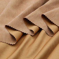 Close-up of Longan Craft's Multi Color Microsuede Polyester Peachskin Fabric by the yard, featuring soft, cozy brushed peach skin texture. Multiple beige and light brown swatches are layered with zigzag-cut edges and a smooth finish.