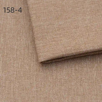 A close-up of Longan Craft Faux Linen Upholstery Fabric by the yard in light brown (158-4), with durable polyester fabric folded over itself for furniture, chair, sofa, or curtain reupholstering.