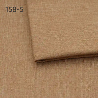 Close-up of Longan Craft Faux Linen Upholstery Fabric in light brown, with one piece folded over another. The number 158-5 is printed in the top left corner. Ideal polyester fabric for reupholstering furniture, chairs, sofas, or curtains.