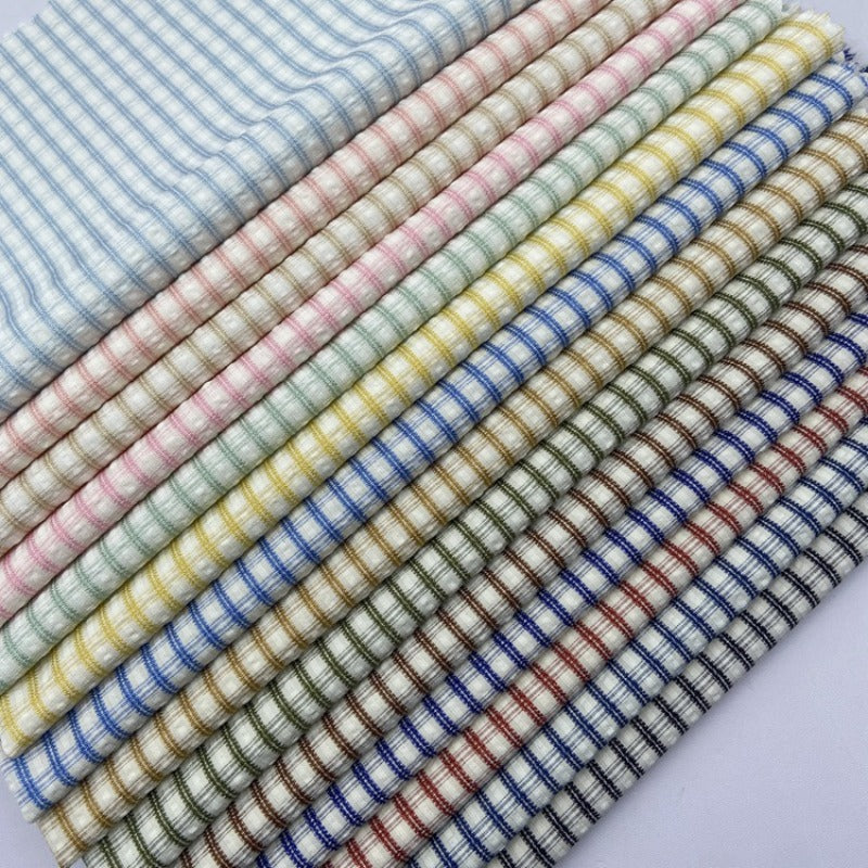 Neatly arranged Vintage Plaid Seersucker Fabric by the Yard from Longan Craft, featuring a polyester-cotton blend and small checkered pastel and muted patterns, ideal for DIY dresses, shirts, and bags.