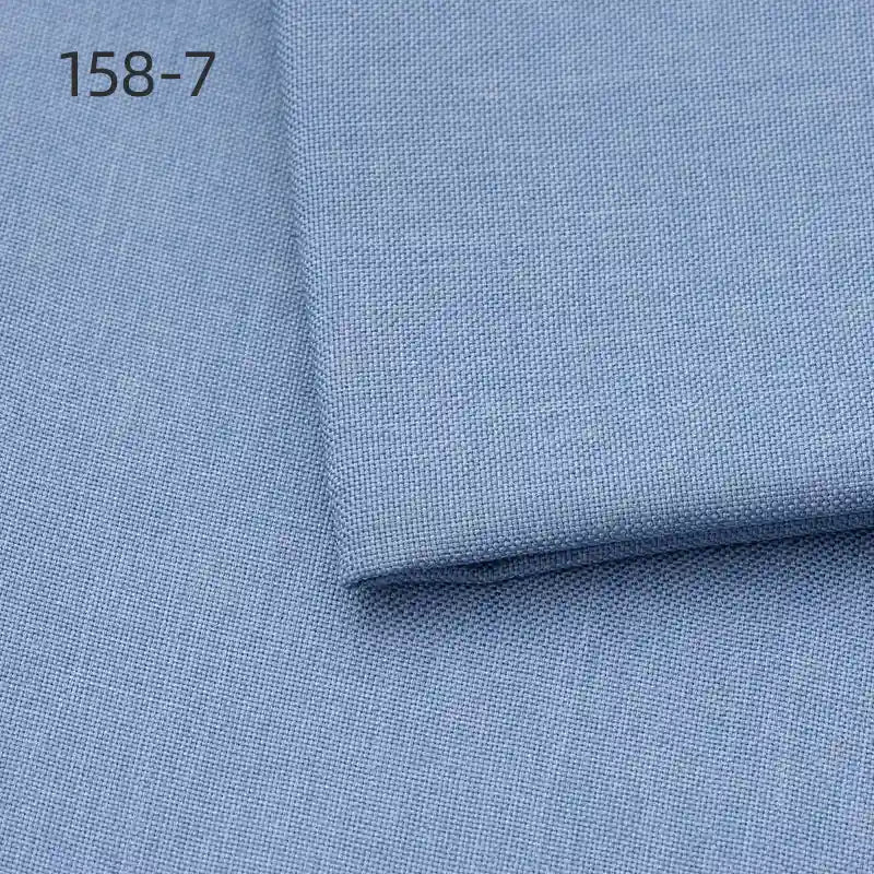 A light blue sample of Longan Craft Faux Linen Upholstery Fabric (polyester) is shown, with a small folded piece on a larger one. The number 158-7 appears in black in the upper left, highlighting this durable reupholstery fabric by the yard.