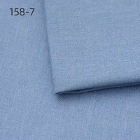 A light blue sample of Longan Craft Faux Linen Upholstery Fabric (polyester) is shown, with a small folded piece on a larger one. The number 158-7 appears in black in the upper left, highlighting this durable reupholstery fabric by the yard.
