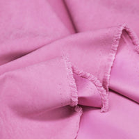 Close-up of Longan Craft Multi Color Microsuede Polyester Peachskin Fabric by the yard, showing its soft, brushed texture and frayed edge—perfect cozy material for clothing.