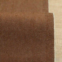 A close-up of Longan Craft 9.5oz Stretch Denim Fabric By The Yard shows its solid color cotton material with fine diagonal weave lines and a clean, even edge—ideal textile for making jeans.