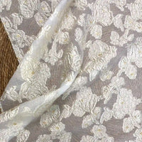The Longan Craft Apricot Rose Embossed Organza Fabric by the yard features 3D white floral jacquard embroidery and bead accents, creating an elegant textured look—ideal soft organza material for summer dresses.