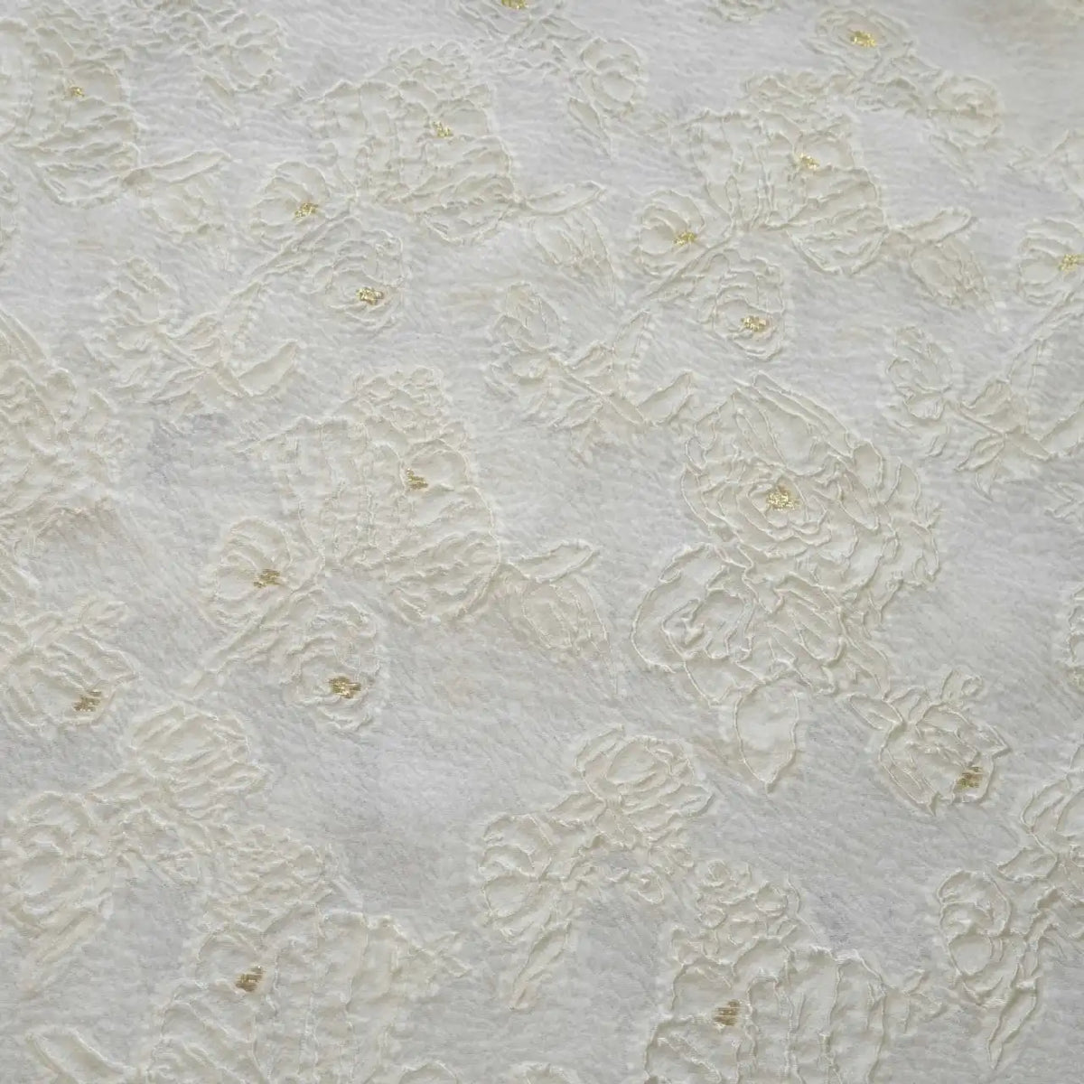 Close-up of Longan Craft's Apricot Rose Embossed Organza Fabric, showcasing its white 3D floral jacquard pattern and subtle gold accents—ideal for summer dresses.