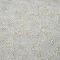 Close-up of Longan Craft's Apricot Rose Embossed Organza Fabric, showcasing its white 3D floral jacquard pattern and subtle gold accents—ideal for summer dresses.