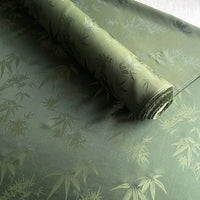 A roll of Longan Craft Bamboo Jacquard Mulberry Silk Fabric is partially unrolled, displaying its silky, slightly shiny texture and subtle bamboo leaf pattern. This colorful rayon silk fabric makes a cozy silk lining material.