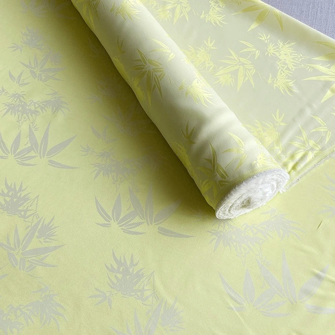A yard of Longan Craft Bamboo Jacquard Mulberry Silk Fabric, a colorful rayon silk with a subtle glossy pattern, is displayed on a flat surface.