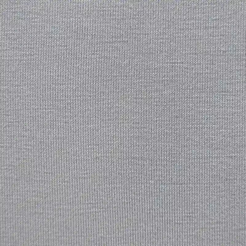Close-up of Longan Craft's Bamboo Jersey Fabric By The Yard—a plain color, single elastane jersey with fine ribbed texture. Soft and eco-friendly, this textile is perfect for loungewear and anyone seeking sustainable fabric options.