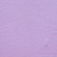 Close-up of Longan Craft's Bamboo Jersey Fabric By The Yard—a soft, plain color single elastane jersey with fine knit texture, ideal for eco-friendly loungewear and baby clothing.
