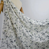 Longan Craft's Bamboo Printed Nylon Viscose Fabric By The Yard features a delicate gray and green leafy chinoiserie print, draped over a mannequin to highlight its lightweight, airy texture—perfect for premium dressmaking projects.