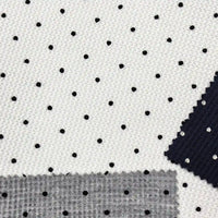 Black Mini Polka Dot Print Waffle Fabric By The Yard in a white waffle-knit, shown with small swatches of navy and grey textured fabric.