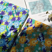 Two botanical printed seersucker cloths from Longan Craft, made of breathable puckered cotton fabric and ideal for spring and summer skirts, are displayed on a sunlit surface beside a paper featuring a photo of succulents and the words GREEN PLANTS. Leaf shadows gently fall across the scene.