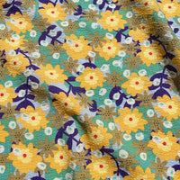 Crafted by Longan Craft, the Botanical Printed Seersucker Fabric By The Yard features a puckered cotton seersucker texture with a vibrant floral pattern showcasing yellow flowers, green leaves, white accents, and touches of purple and blue set against a turquoise background. This breathable fabric is an ideal choice for stylish and comfortable spring or summer skirt projects.
