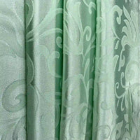 Longan Craft’s Brocade Damask Fabric By The Yard offers luxurious vintage jacquard material for curtains, featuring a subtle floral and leaf pattern in light green with a slight sheen for an elegant, refined look.