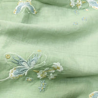 Butterfly Floral Embroidered Ramie Fabric by Longan Craft features light green pure ramie with embroidered butterflies and white flowers in pale yellow and blue threads—a soft, eco-friendly fabric perfect for dresses and sewing.