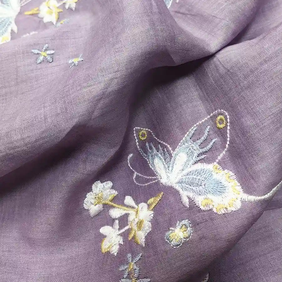 Longan Craft’s Butterfly Floral Embroidered Ramie Fabric by the Yard features fine white and yellow embroidery on light purple 100% ramie, perfect for soft dresses and delicate sewing projects.