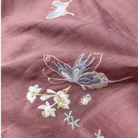 Close-up of Butterfly Floral Embroidered Ramie Fabric by the yard from Longan Craft, featuring blue and yellow butterflies, dragonflies, and delicate flowers on pure eco-friendly thin 100 ramie material for soft dresses.