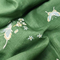 Longan Craft's Butterfly Floral Embroidered Ramie Fabric features light blue and yellow butterflies with white flowers on green eco-friendly ramie, perfect for soft dresses and sewing projects.
