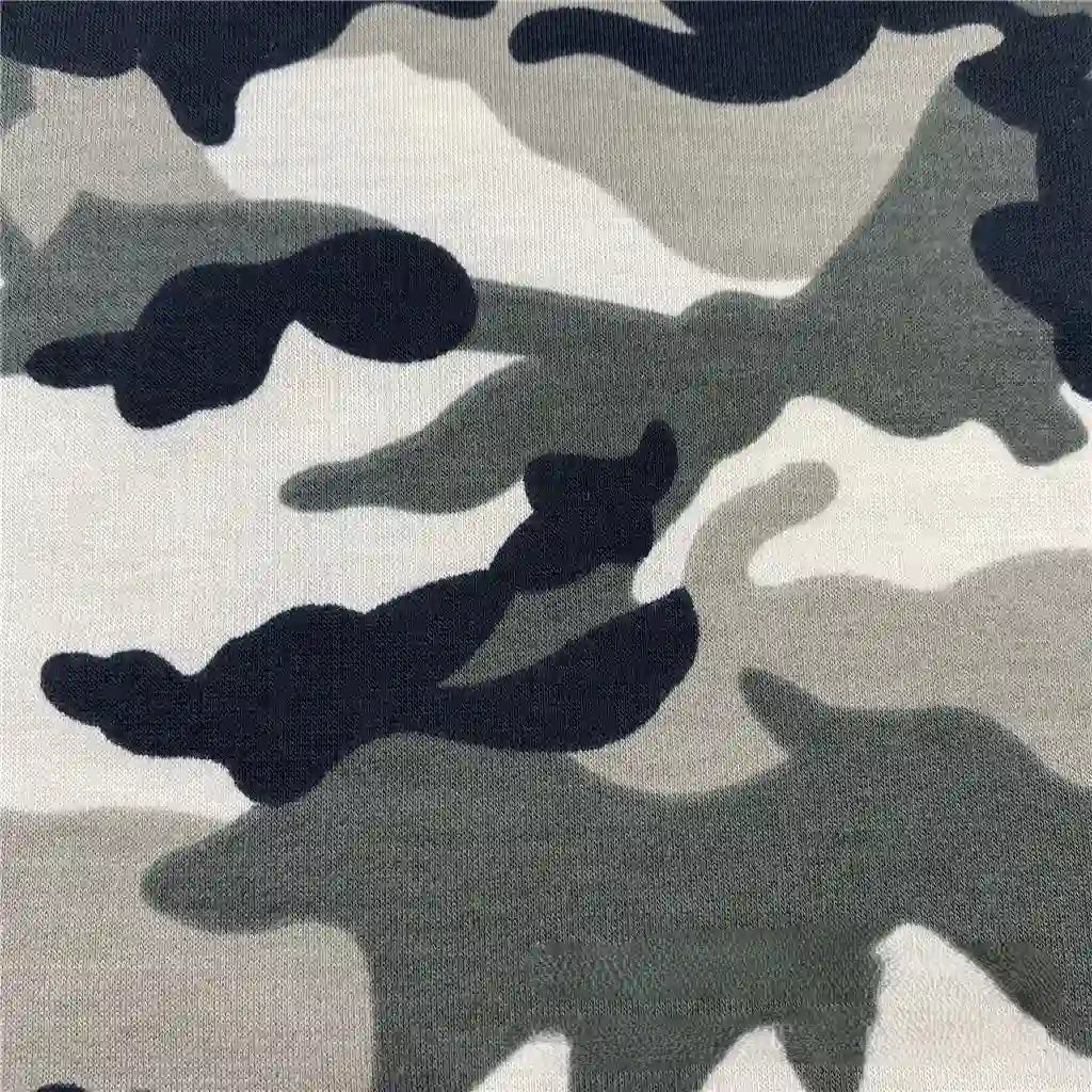 A close-up of Longan Craft's Camo Printed Stretch French Terry Fabric By The Yard shows a classic black, gray, and white camouflage pattern—breathable and perfect for sports apparel or sweatshirts.