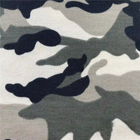 A close-up of Longan Craft's Camo Printed Stretch French Terry Fabric By The Yard shows a classic black, gray, and white camouflage pattern—breathable and perfect for sports apparel or sweatshirts.