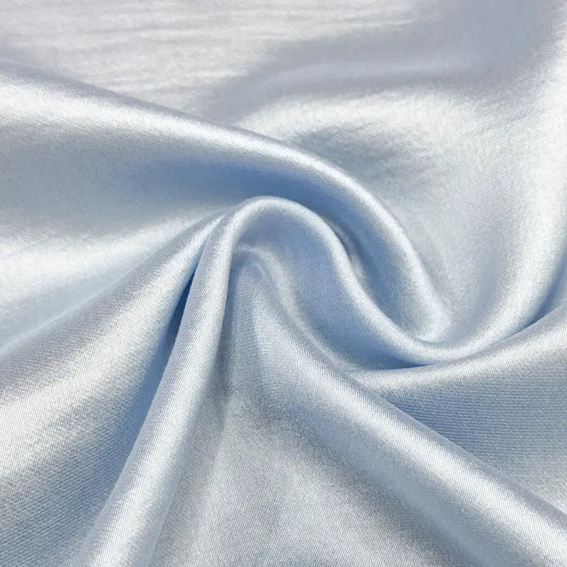Close-up of Longan Craft's Charmeuse Mulberry Silk Fabric By The Yard, a multicolor rayon poly blend with a soft sheen, draped in smooth folds—ideal soft silk material for dresses.