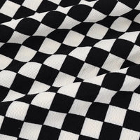 A close-up of Longan Craft’s Checkered Corduroy Fabric By The Yard shows evenly spaced black and white checks on soft, printed polyester corduroy, with vintage-style ribbed texture ideal for apparel projects.