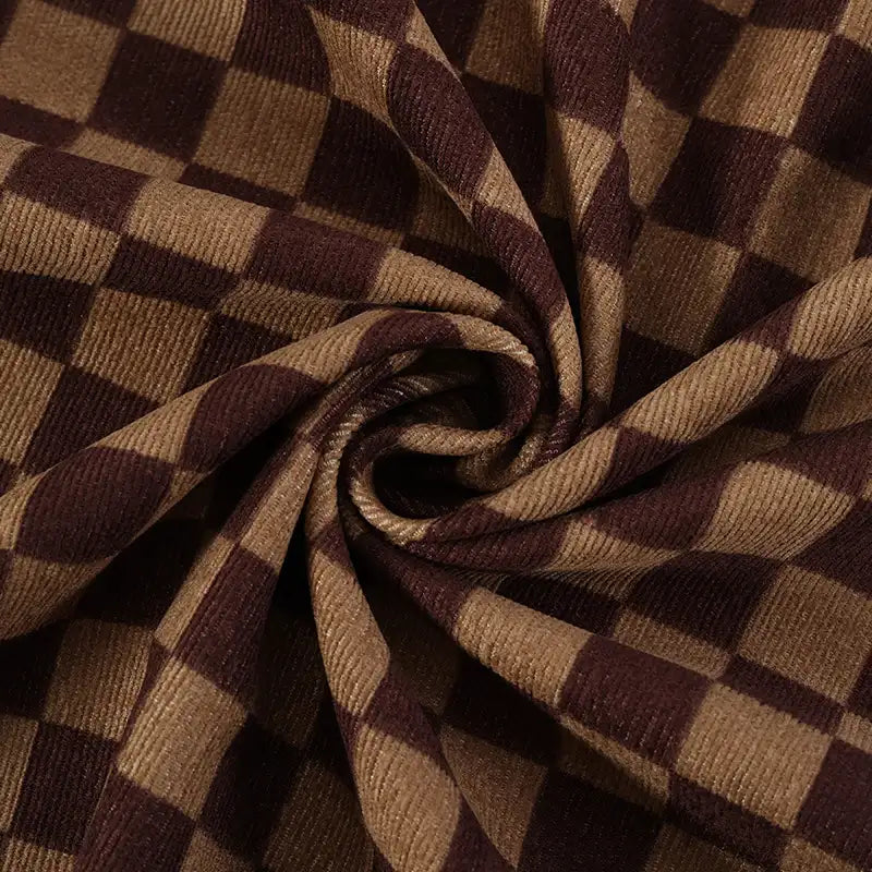 Close-up of Longan Craft's Checkered Corduroy Fabric By The Yard, a soft printed polyester corduroy with a vintage brown and tan checkered design, shown with ribbed texture gathered in a spiral pattern.
