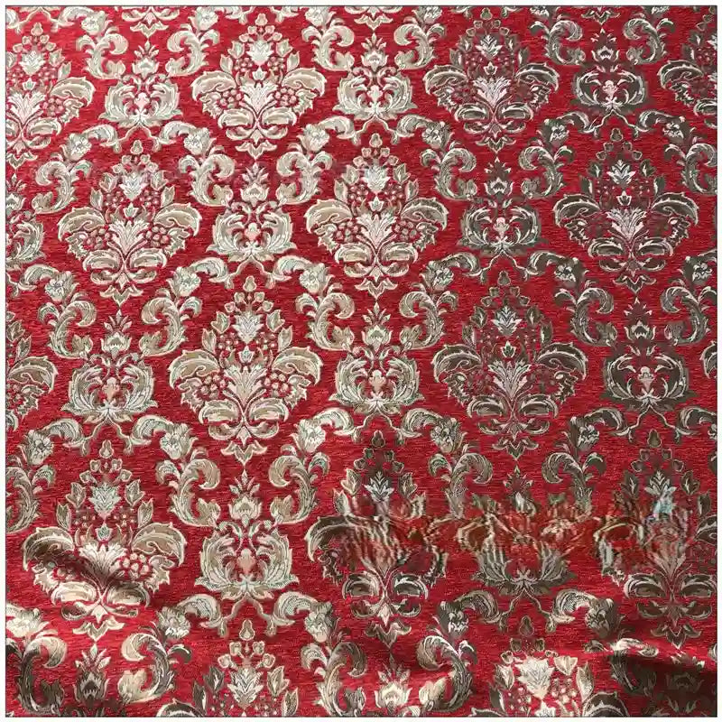 Longan Craft's Chenille Damask Fabric by the yard features a red background with gold and silver symmetrical floral jacquard motifs. This elegant damask upholstery fabric may show slight wrinkles in the lower area.