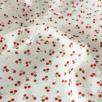 Longon Craft Cherry Print Double Gauze Fabric by the yard features small red cherries with green stems on soft, crinkled cotton—perfect muslin fabric for sewing children’s clothing and projects.