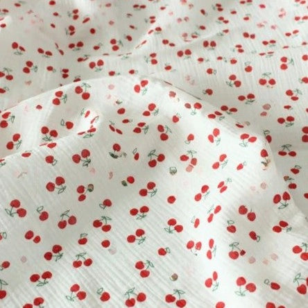 Longon Craft Cherry Print Double Gauze Fabric by the yard features small red cherries with green stems on soft, crinkled cotton—perfect muslin fabric for sewing children’s clothing and projects.
