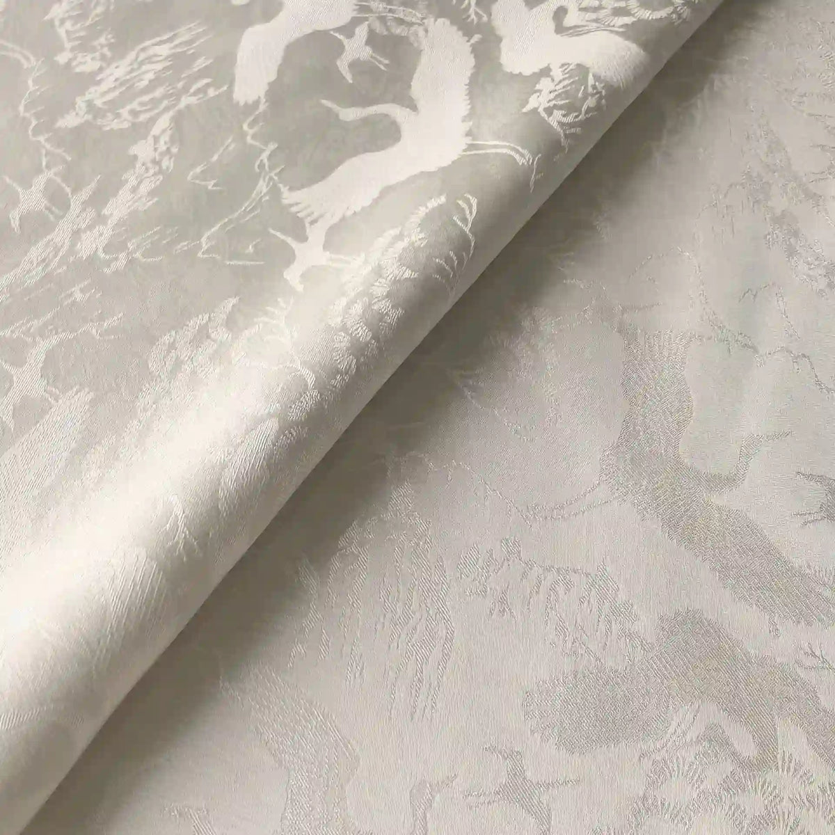 Close-up of Longan Craft's Chinoiserie Polyester Viscose Fabric by the yard—a botanical jacquard material with a subtle, intricate woven pattern and a slightly shiny, textured finish, ideal for curtains and elegant dressmaking.