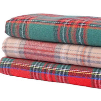 Three folded wool fabrics with plaid patterns are stacked: the top features green with red and white lines, the middle showcases beige with red and gray stripes, and the bottom displays red with green and blue stripes. These timeless designs from Longan Craft’s “Christmas Plaid Sueded Flannel Fabric By The Yard” collection are perfect choices for holiday sewing projects or cozy brushed flannel crafts, making them ideal checked holiday flannel material for classic dresses or festive décor.