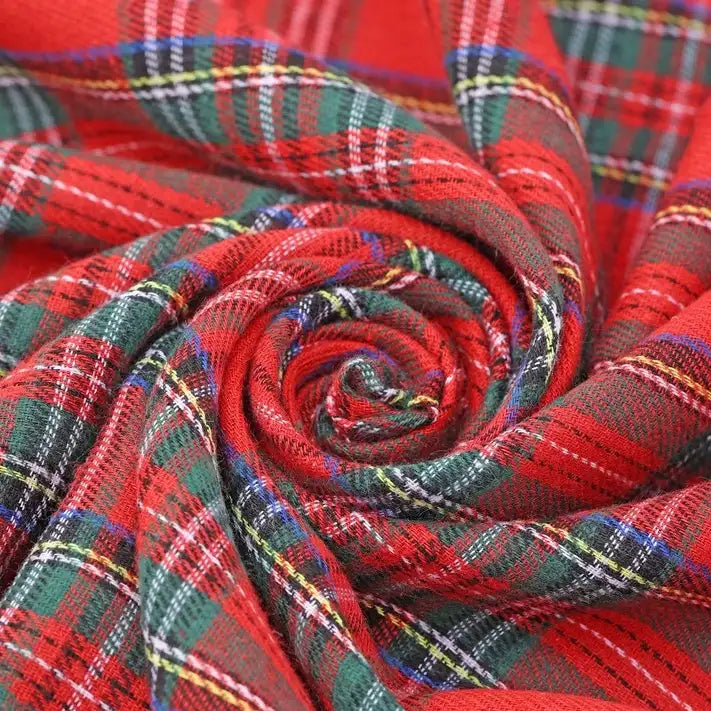 A close-up of the Longan Craft Christmas Plaid Sueded Flannel Fabric By The Yard, featuring a spiral arrangement that showcases its vibrant green, white, yellow, and blue stripes on red tartan—this checked holiday flannel sewing material highlights its soft sueded texture and colorful plaid design, making it perfect for classic dresses and festive projects.