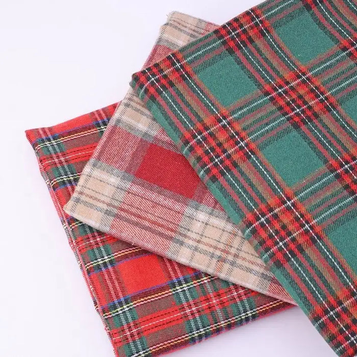 Three folded pieces of Longan Craft Christmas Plaid Sueded Flannel Fabric by the Yard, featuring red, green, and beige checked holiday patterns, are stacked on a white background. This soft sueded flannel sewing material is perfect for festive projects and classic dresses, adding warmth and seasonal charm to your creations.