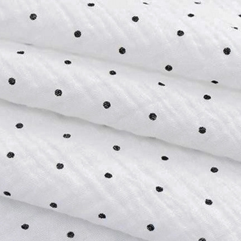 Close-up of Longan Craft's Classic Small Polka Dot Gauze Fabric by the yard—100% cotton double gauze with a textured white surface and evenly spaced black polka dots, ideal for baby clothing and pajamas.