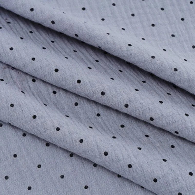 Longan Craft's Classic Small Polka Dot Gauze Fabric By The Yard—100% cotton double gauze with evenly spaced black dots—is perfect for baby clothing and pajamas.