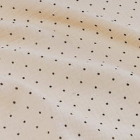A close-up of Longan Craft's Classic Small Polka Dot Gauze Fabric shows soft beige 100% cotton double gauze with evenly spaced small black dots, ideal for baby clothing or pajamas, available by the yard.
