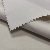 Close-up of Longan Craft's Coated Waterproof Peachskin Fabric by the yard, a microfiber polyester material with a soft, smooth texture and zigzag-cut edge, showcasing its clean finish and waterproof quality—perfect for jacket making.