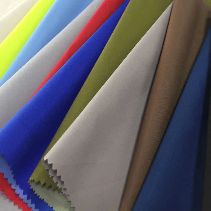Longan Craft’s Coated Waterproof Peachskin Fabric By The Yard, made from microfiber polyester peachskin, is shown in a fan arrangement of solid blue, red, green, brown, beige, and yellow—perfect for cozy jacket projects.