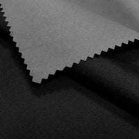 A close-up of two overlapping Longan Craft Coated Waterproof Peachskin Fabrics—one light gray, one black—both smooth and matte, expertly crafted from microfiber polyester, ideal for making cozy, waterproof jackets.