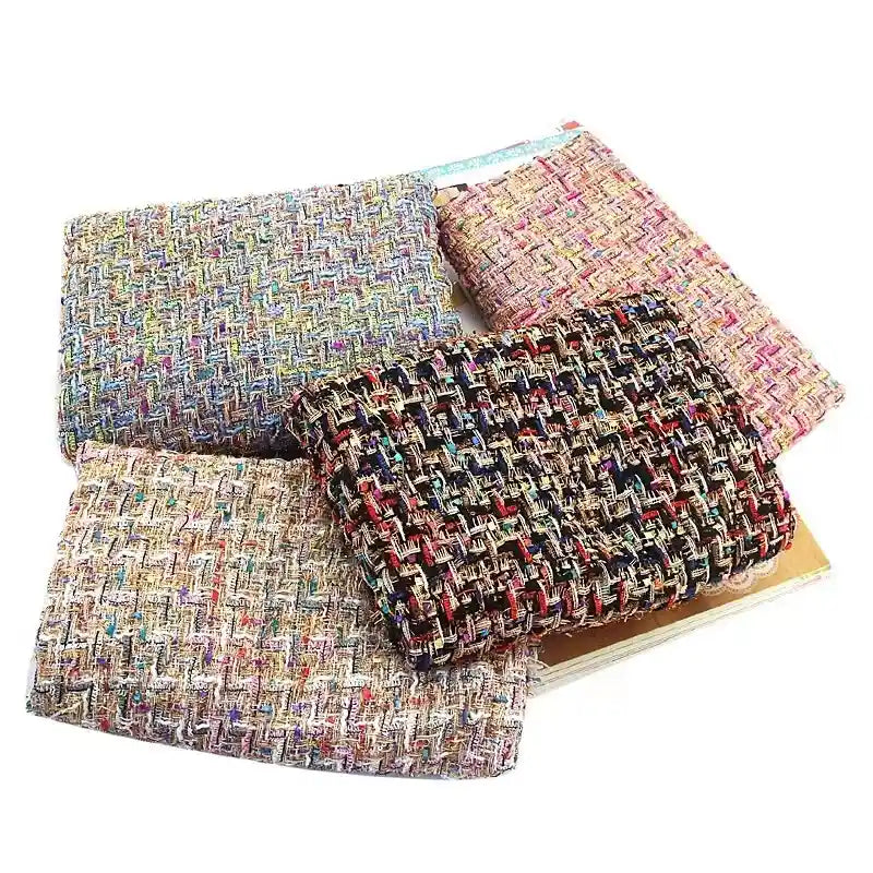 Four folded pieces of Longan Craft’s Colorful Boucle Tweed Fabric By The Yard, a luxurious, thick, and textured woven tweed fabric ideal for blazers and clothing, are arranged on a flat surface, showcasing various vibrant colors and patterns.