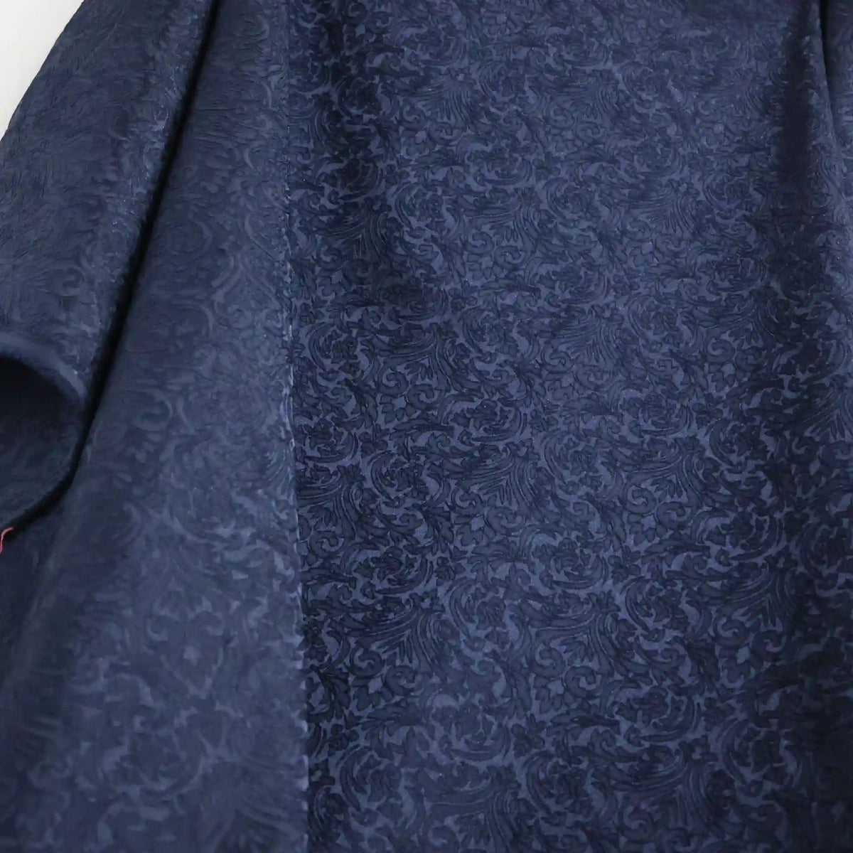 A close-up of Longan Craft's Colorful Brocade Damask Fabric By The Yard highlights its intricate, raised jacquard damask pattern and subtle sheen, making it ideal as a patterned dress material or for elegant textile projects.