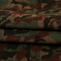 Close-up of Longan Craft’s Colorful Camouflage Corduroy Fabric By The Yard, showing its thick, ribbed texture and classic green, brown, and black print—a quality material perfect for clothing and crafts.