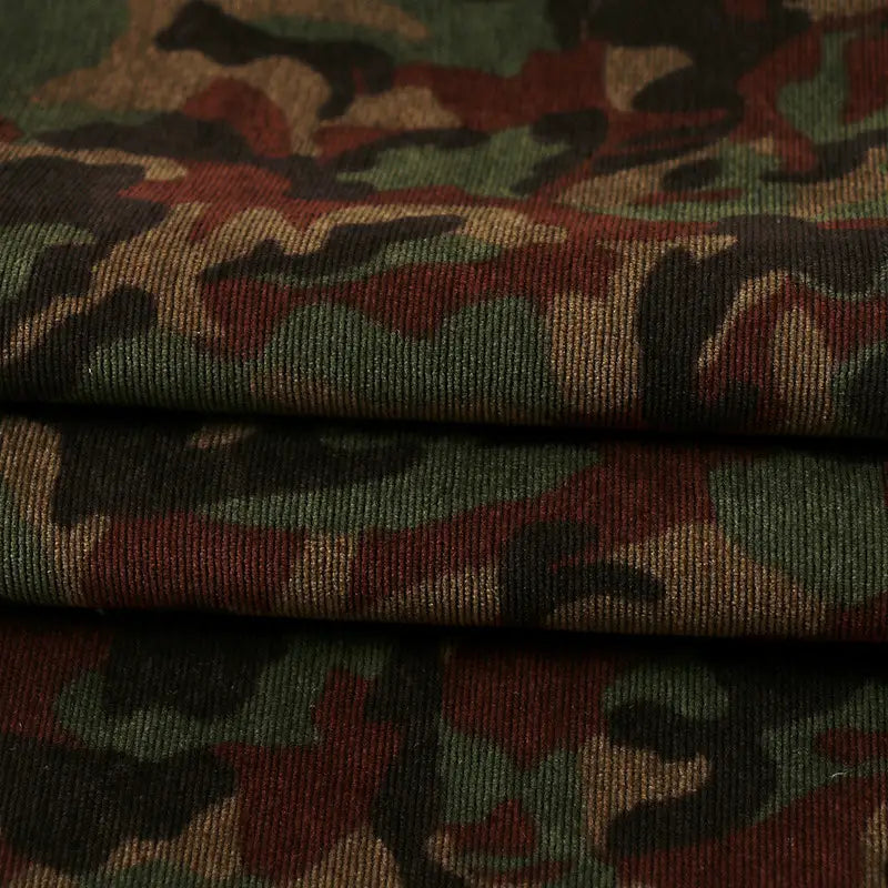 Close-up of Longan Craft’s Colorful Camouflage Corduroy Fabric By The Yard, showing its thick, ribbed texture and classic green, brown, and black print—a quality material perfect for clothing and crafts.