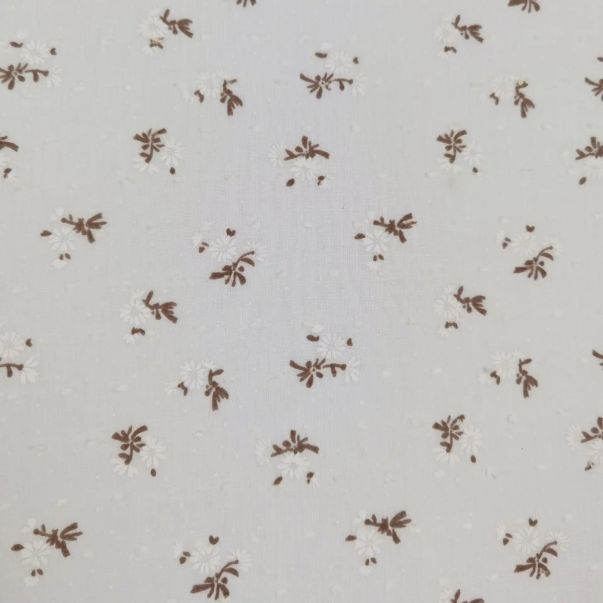 Longan Craft Colorful Daisy Print Swiss Dot Fabric by the yard is 100% cotton, featuring a dotted texture and vibrant daisy flower print—perfect for breathable, casual wear.
